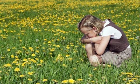 Young Girl Sitting in Flowers
